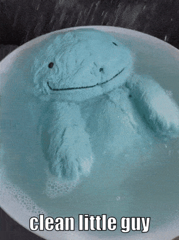 Blue Stuffed Animal Floating in Water Saying Clean Little Guy