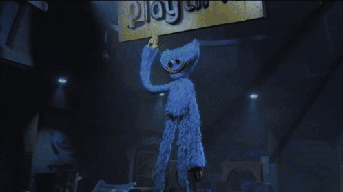 Blue Stuffed Animal Holding Play Sign GIF