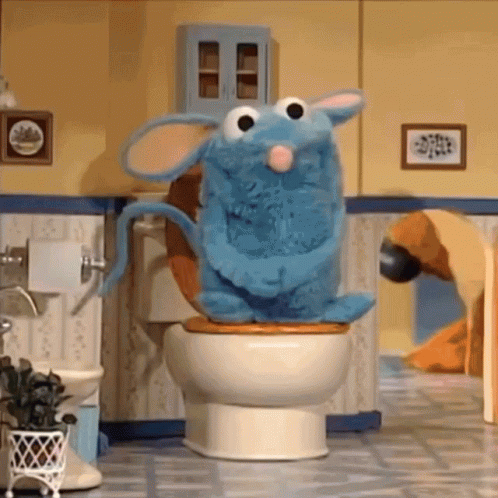 Blue Stuffed Animal Sitting On Toilet GIF