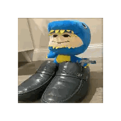 Blue Stuffed Dinosaur on Shoes