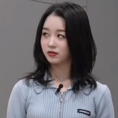 Blue Sweater Woman With Zipper and Necklace Looking at Camera