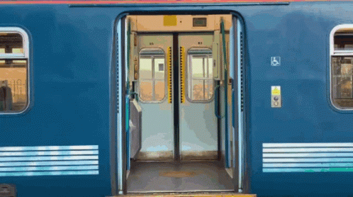 Blue Train With Open Doors and Handicapped Sign