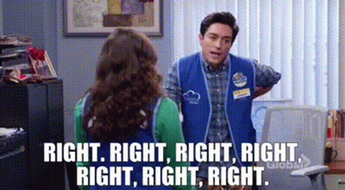 Blue Vest Man Talking to Green Shirt Woman