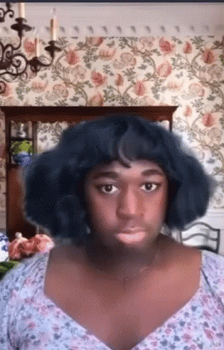 Blue Wig Floral Top Woman Looking at Camera
