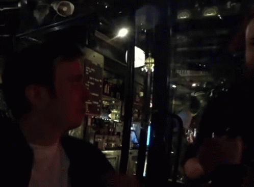 Blurred Man in Bar with Menu on Wall
