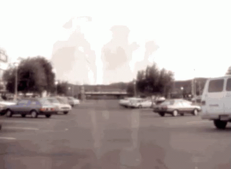 Blurred Parking Lot With Cars And Van GIF