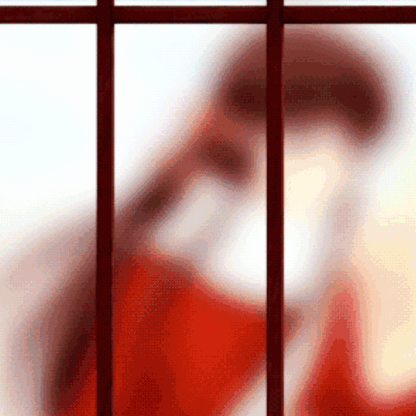 Blurred Person in Red Shirt Behind Bars