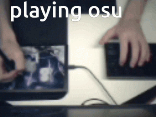 Blurred Person Playing Osu on Laptop