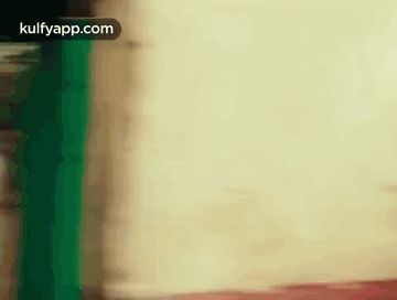 Blurred Person Standing in Front of White Wall