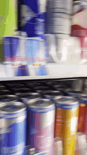 Blurred Store Shelf with Cans and Cups