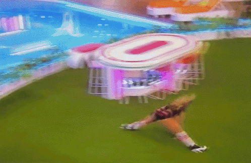 Blurred Woman Lying On Grass By Building Number 0 GIF