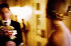Blurry Bride and Groom Holding Flowers