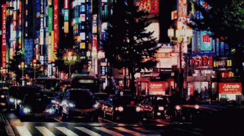 Blurry City Street at Night With Adonis Sign