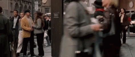 Blurry Crowd Walking Down City Street GIF