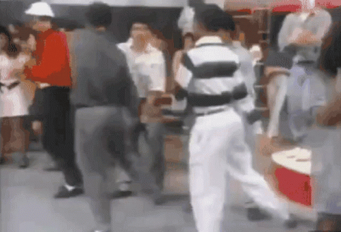 Blurry Group of People Dancing in Front of Red Cooler