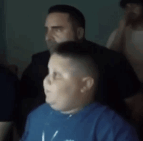 Blurry Man and Boy in Blue Shirt