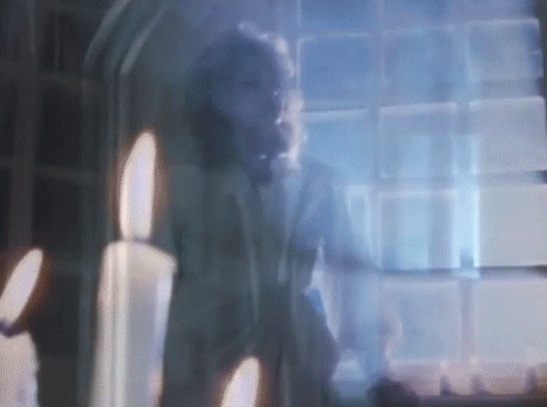 Blurry Man at Window with Candles