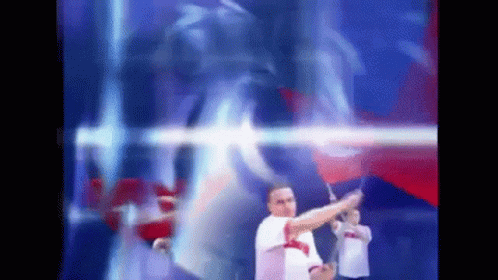 Blurry Man Holding Flag in Front of Blue and Red Background