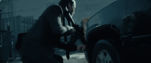 Blurry Man Holding Gun In Dark Room GIF