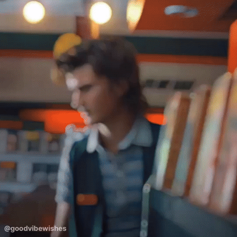 Blurry Man Holding Sandwiches in Restaurant