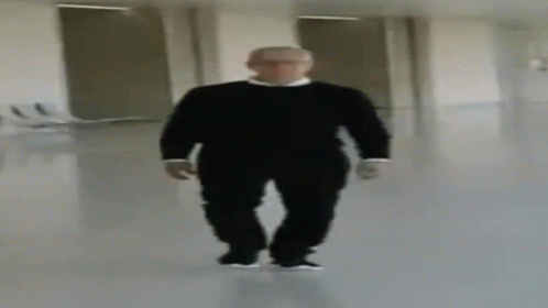 Blurry Man in Black Sweater Walking Down Hallway