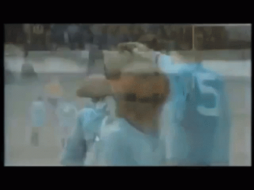 Blurry Man In Blue Shirt With Number 5 GIF