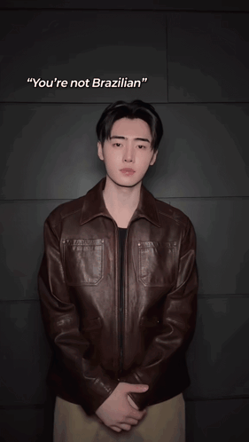 Blurry Man in Brown Jacket With OK