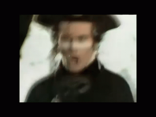 Blurry Man In Hat And Black Coat GIF