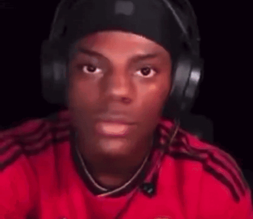 Blurry Man in Red Shirt With Headphones