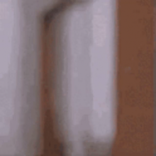 Blurry Man Peeking Behind Wall