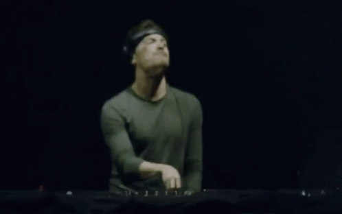 Blurry Man Playing Keyboard In Dark Room GIF