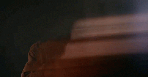Blurry Man's Face in Dark Room