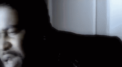 Blurry Man's Face in Dark Room