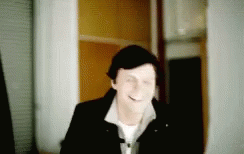Blurry Man Smiling in Hallway