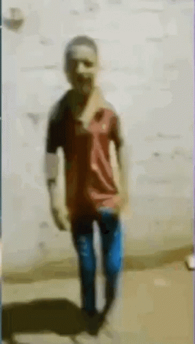 Blurry Man Standing in Front of Wall
