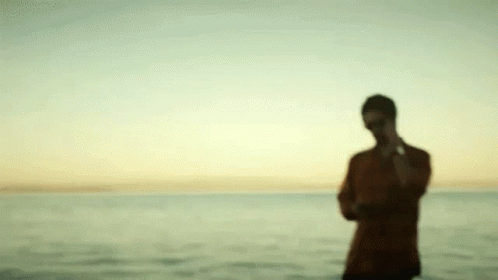 Blurry Man Standing on Beach