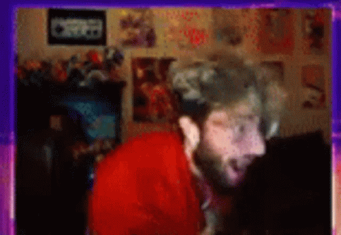 Blurry Man With Beard in Room With Posters
