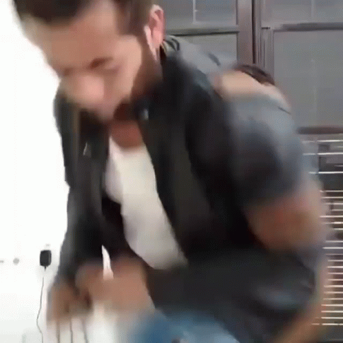 Blurry Man With Ear Buds in Black Jacket