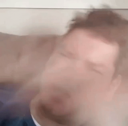 Blurry Man With Eyes Closed Behind Glass GIF