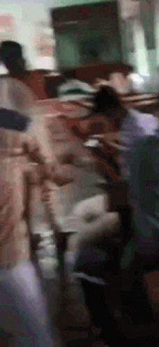 Blurry People Standing Around Table GIF