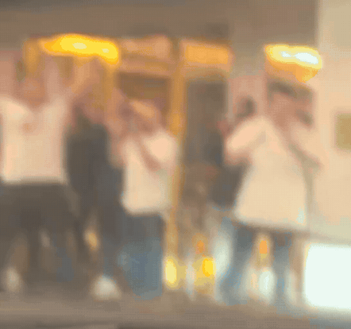 Blurry People Standing in Front of Payphone