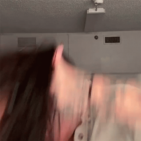 Blurry Person Head in Front of Ceiling Light