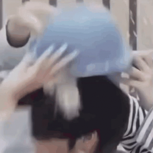 Blurry Person Holding Blue Object
