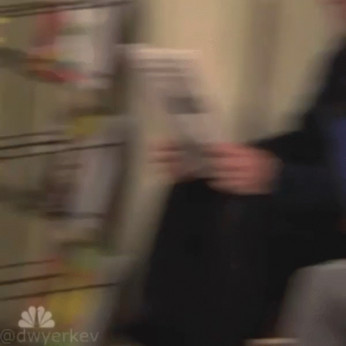 Blurry Person Holding Newspaper GIF