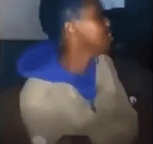 Blurry Person in Blue Shirt and White Jacket