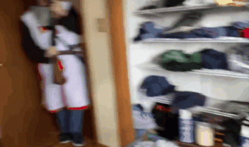 Blurry Person in Closet With Clothes