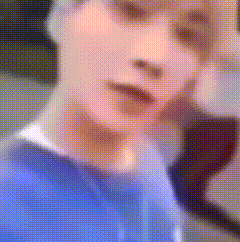 Blurry Person's Face in Blue Shirt