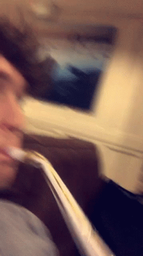 Blurry Person Sitting On Couch With Straw GIF