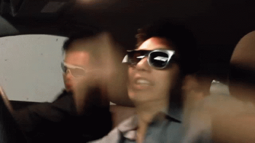 Blurry Photo of Man in Sunglasses in Car