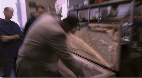 Blurry Picture of Man Reaching Into Container